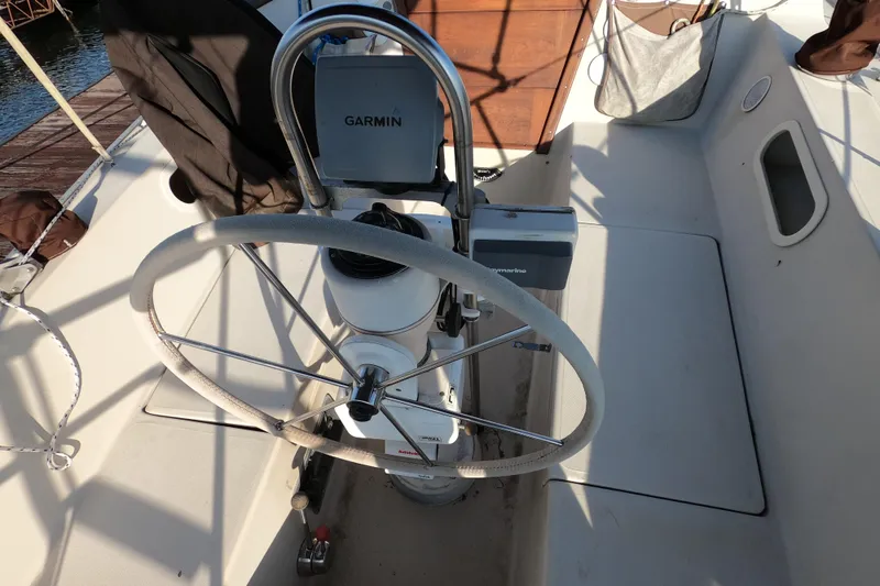 Slide: The Image of 1980 Catalina 30 sailboat cockpit with steering wheel and Garmin navigation system. - 8