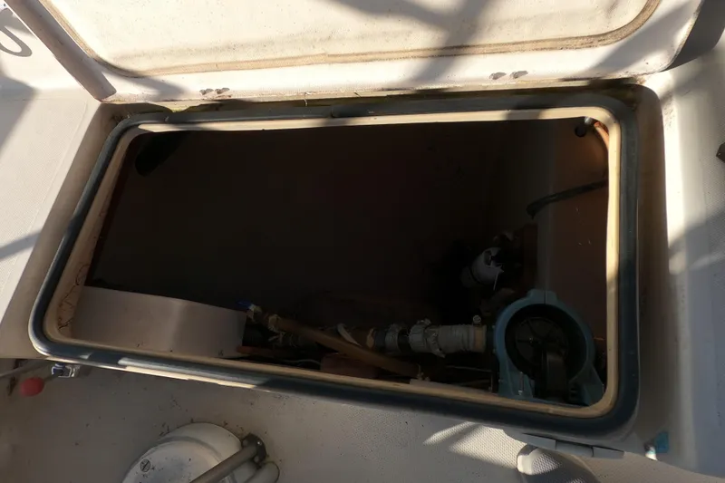 Slide: The Image of Open hatch on 1980 Catalina 30 sailboat, revealing interior mechanical components. - 9