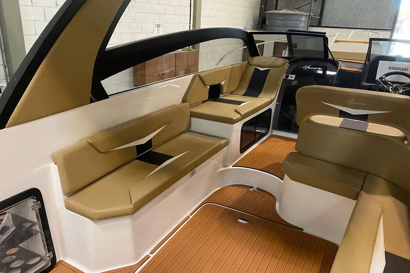 Slide: The Image of 2026 Hanover 305 boat interior with tan seating and wood flooring. - 5