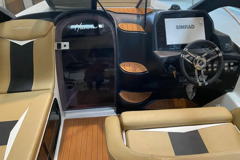 Slide: The Image of 2026 Hanover 305 boat interior with Simrad display and stylish seating. - 6