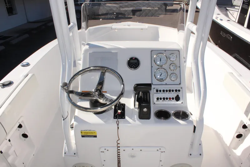 Slide: The Image of 2024 Clearwater 2000 CC boat console with steering wheel and control panel. - 10