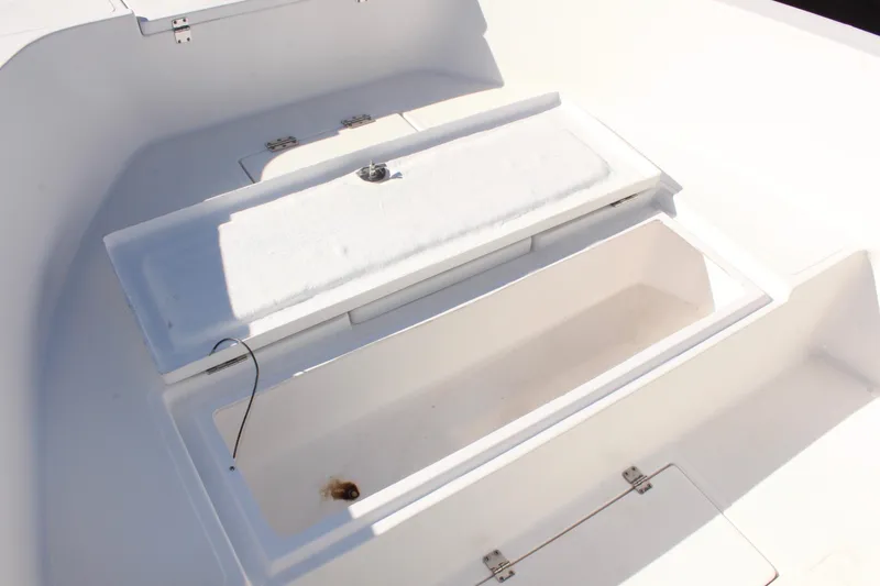 Slide: The Image of Open storage compartment on 2024 Clearwater 2000 CC boat, showcasing interior space. - 14