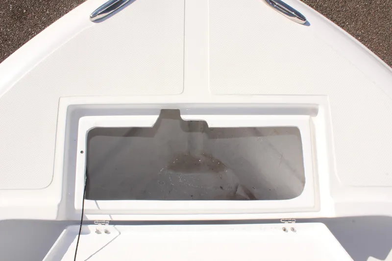 Slide: The Image of 2024 Clearwater 2000 CC boat storage compartment with open hatch. - 16