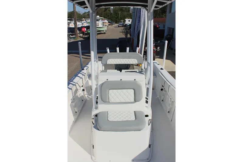Slide: The Image of 2024 Clearwater 2000 CC boat interior with cushioned seating and center console. - 17