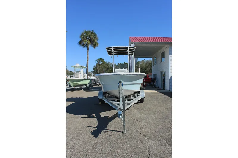 Slide: The Image of 2024 Clearwater 2000 CC boat on trailer, parked outdoors under clear blue sky. - 3