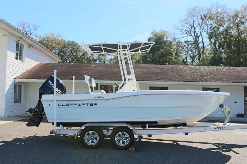 Slide: The Image of 2024 Clearwater 2000 CC boat on trailer, parked outdoors near a building. - 5