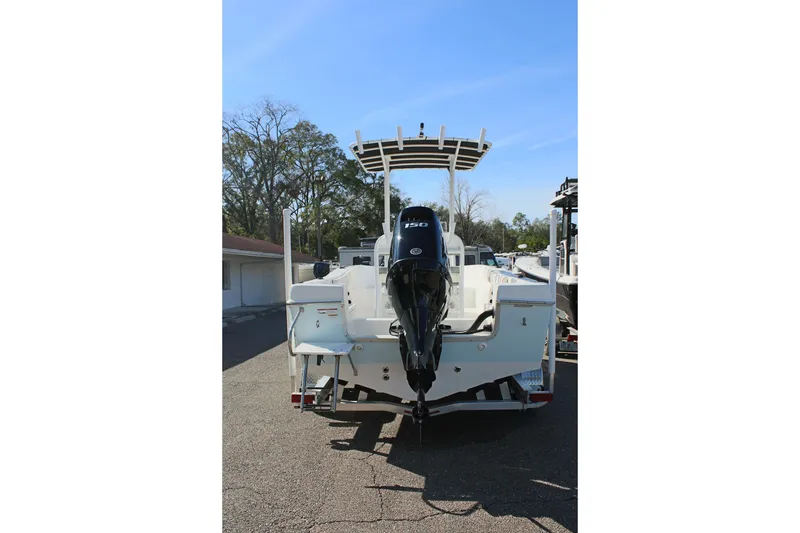 Slide: The Image of 2024 Clearwater 2000 CC boat with outboard motor, parked outdoors. - 7