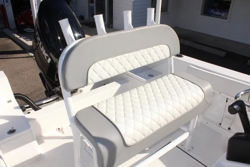 Slide: The Image of 2024 Clearwater 2000 CC boat with white cushioned seating and Suzuki outboard motor. - 9