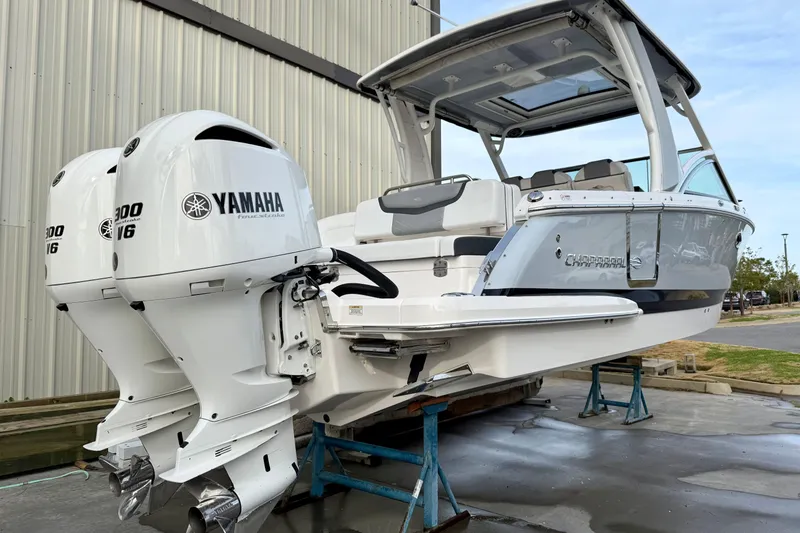 Slide: The Image of 2020 Chaparral 300 OSX boat with twin Yamaha engines, docked outdoors. - 15