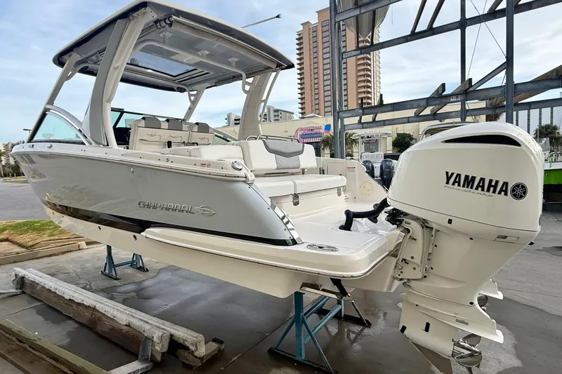 Slide: The Image of 2020 Chaparral 300 OSX boat with Yamaha engine, displayed on a stand outdoors. - 18