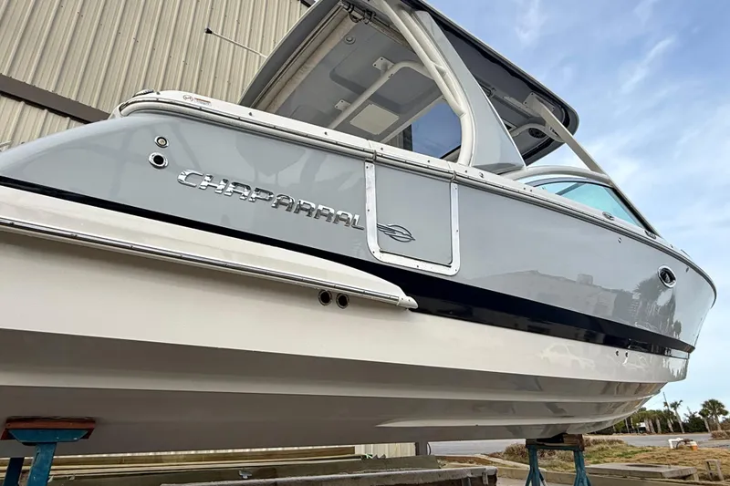 Slide: The Image of 2020 Chaparral 300 OSX boat displayed outdoors, showcasing sleek design and branding. - 19
