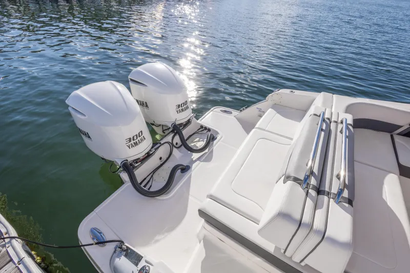 Slide: The Image of 2020 Chaparral 300 OSX boat with twin Yamaha 300 engines on calm water. - 27