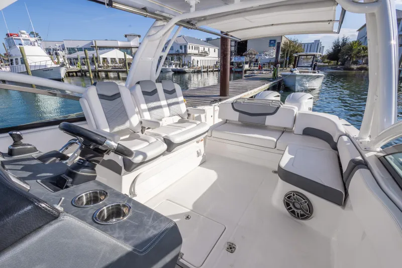 Slide: The Image of 2020 Chaparral 300 OSX boat interior with seating, docked at marina. - 29
