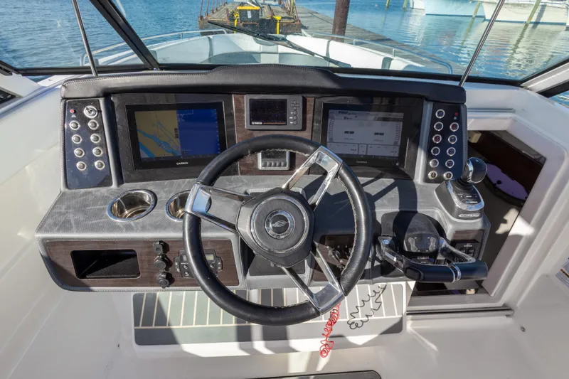 Slide: The Image of 2020 Chaparral 300 OSX helm with modern controls and navigation screens. - 36