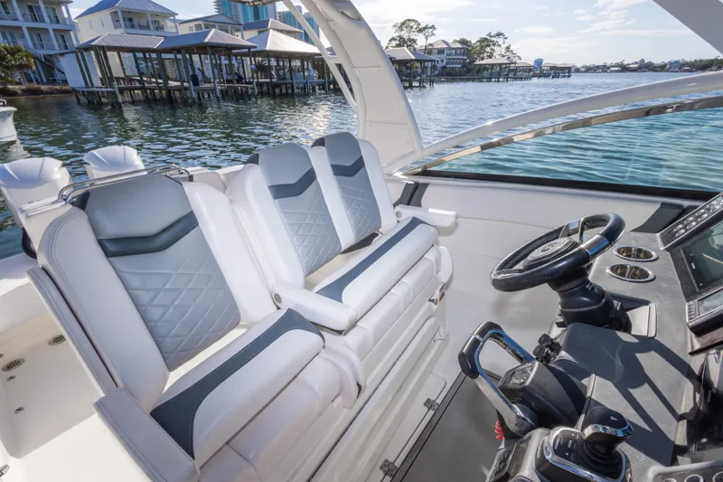 Slide: The Image of 2020 Chaparral 300 OSX boat interior with luxury seating and modern helm controls. - 38