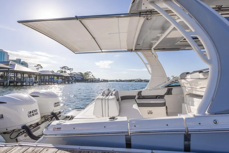Slide: The Image of 2020 Chaparral 300 OSX boat with Yamaha engines, docked by waterfront under sunny sky. - 41