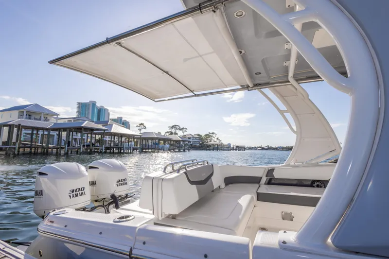 Slide: The Image of 2020 Chaparral 300 OSX boat with Yamaha engines, dockside view, sunny day. - 42
