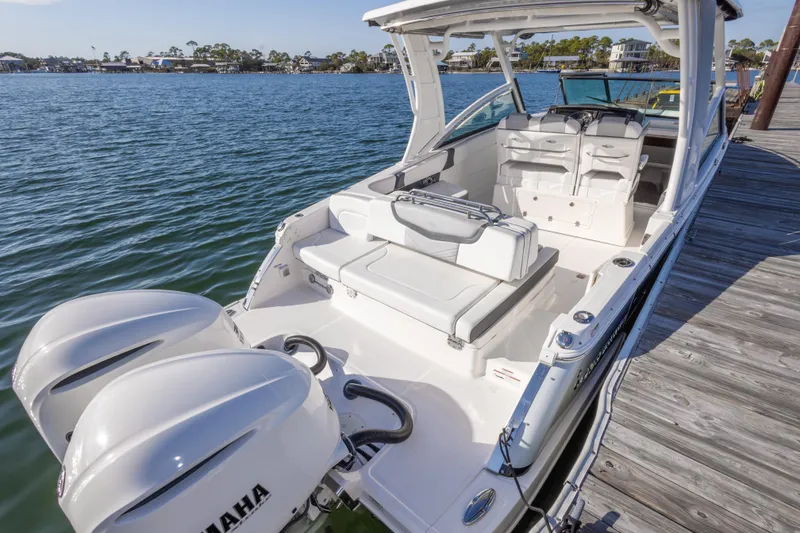 Slide: The Image of 2020 Chaparral 300 OSX boat docked, featuring dual Yamaha engines and spacious seating. - 44