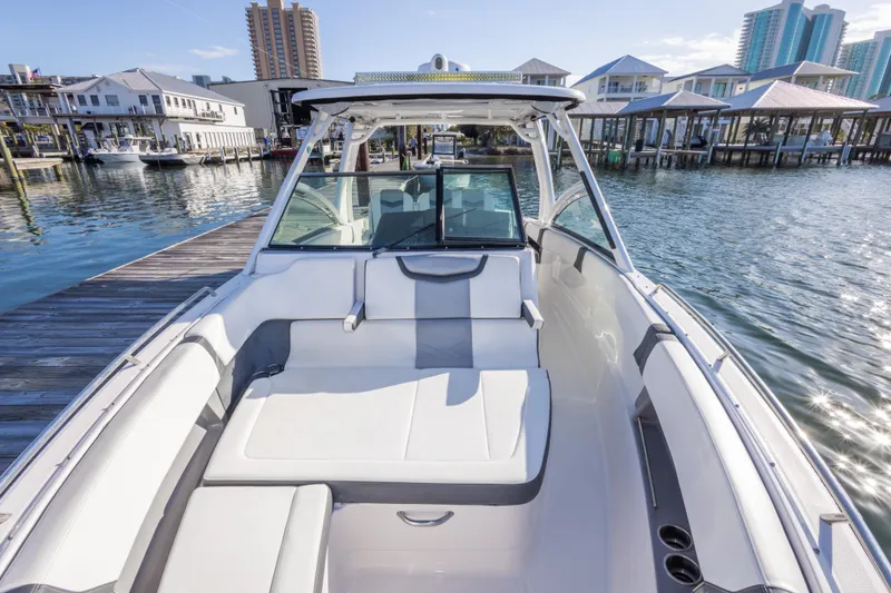 Slide: The Image of 2020 Chaparral 300 OSX boat docked, featuring spacious seating and modern design. - 46