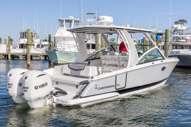 Slide: The Image of 2020 Chaparral 300 OSX boat with twin Yamaha 300 V6 engines docked at marina. - 6