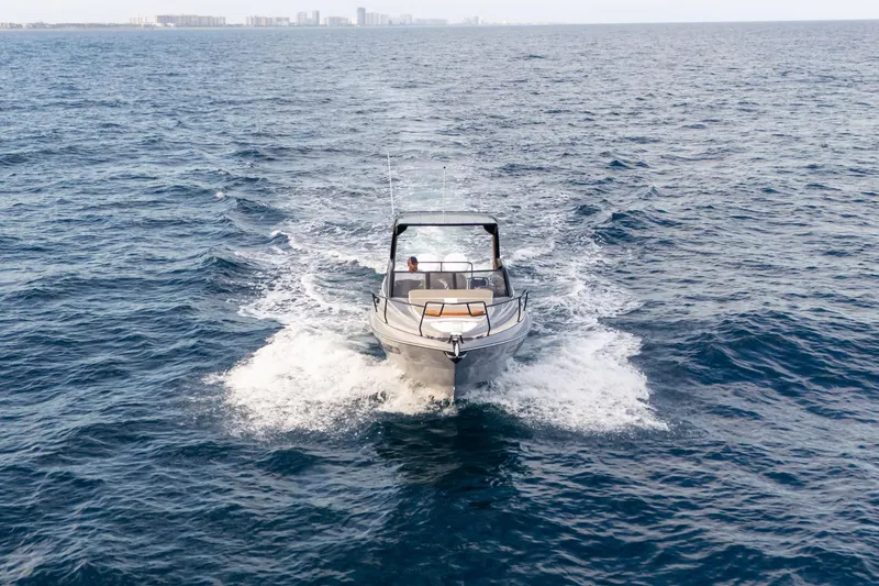 Slide: The Image of 2026 Hanover 305 boat cruising on open ocean waters. - 11