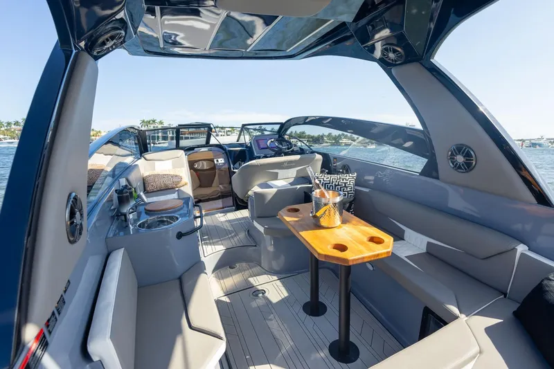 Slide: The Image of Luxurious 2026 Hanover 305 boat interior with seating, table, and scenic water view. - 26