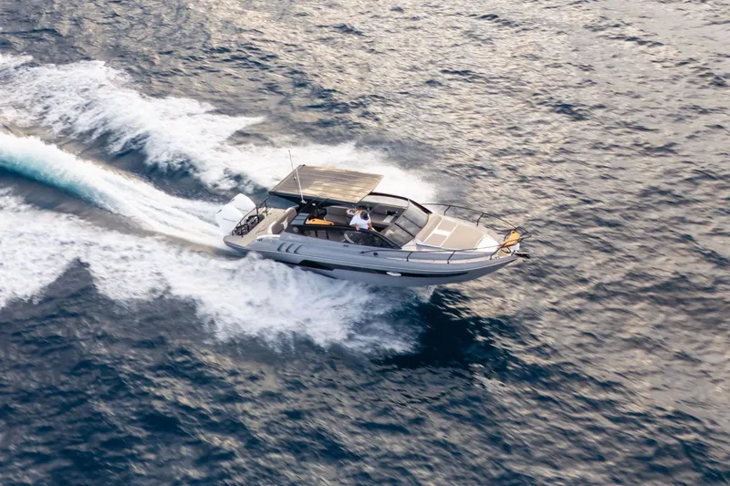 Slide: The Image of Aerial view of 2026 Hanover 305 speedboat cruising on open water. - 8