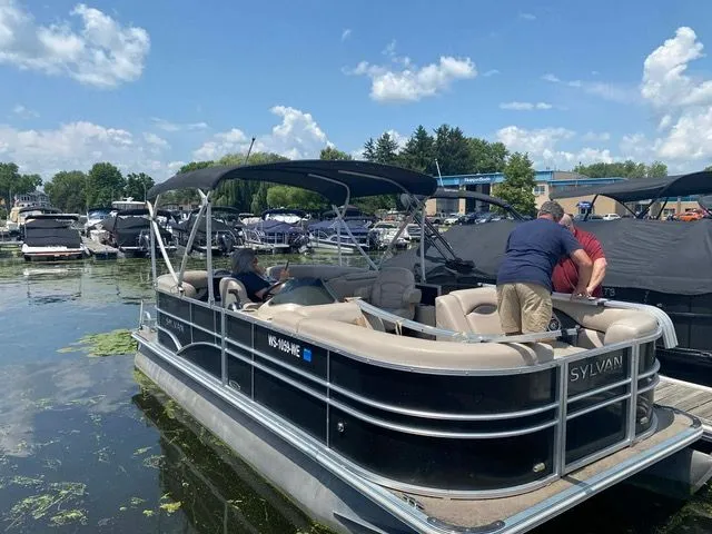 Slide: The Image of Sylvan Mirage 8520 LZ pontoon boat docked, 2016 model. - 2