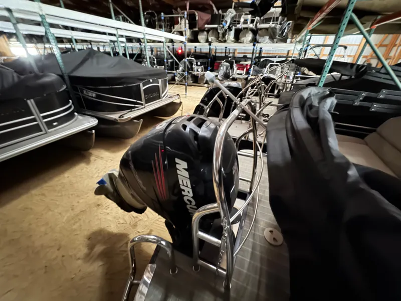 Slide: The Image of 2018 Harris 240 Solstice pontoon boat in storage with Mercury engine. - 22