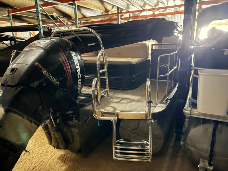 Slide: The Image of 2018 Harris 240 Solstice pontoon boat with Mercury engine in storage facility. - 25