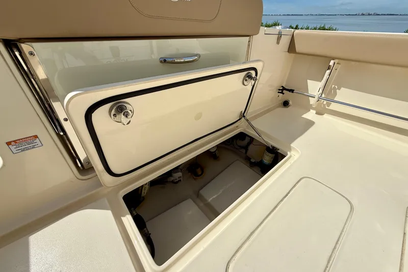 Slide: The Image of 2025 Scout 240 XSF boat storage compartment open, showcasing interior details. - 10