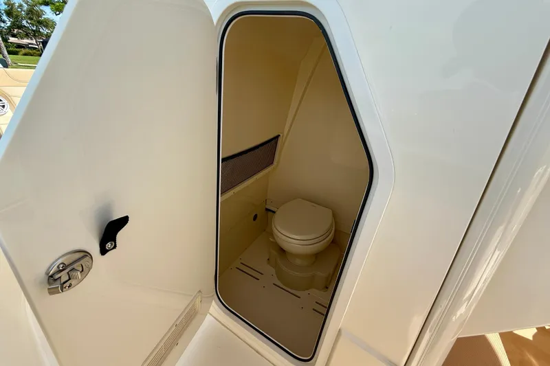 Slide: The Image of 2025 Scout 240 XSF boat interior with compact marine toilet. - 23
