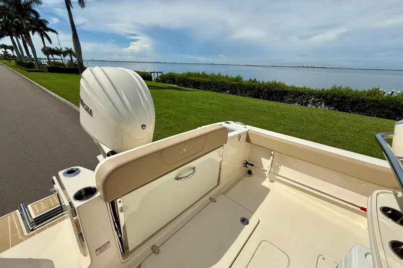 Slide: The Image of 2025 Scout 240 XSF boat with Yamaha engine, scenic waterfront view. - 8