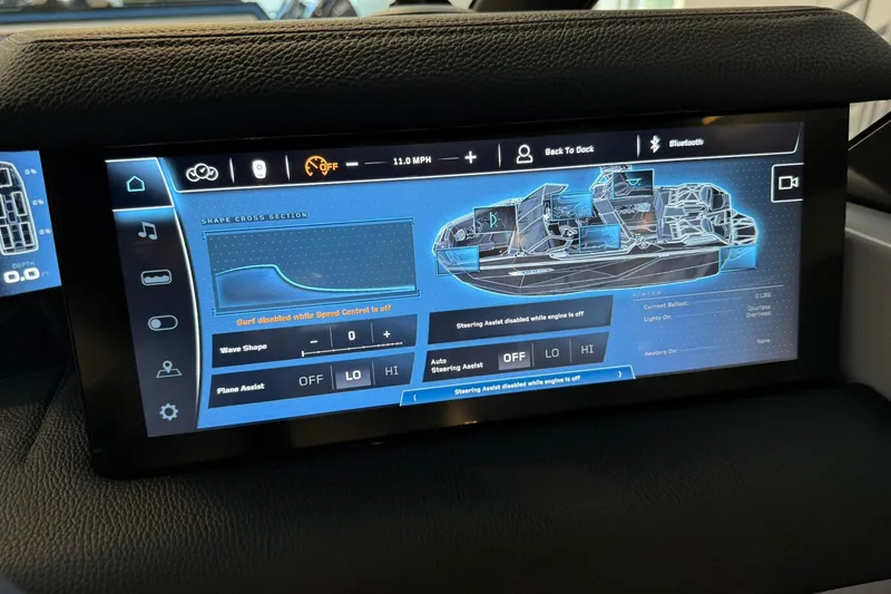 Slide: The Image of 2026 Nautique Super Air Nautique G25 Paragon touchscreen display showing boat controls and settings. - 18