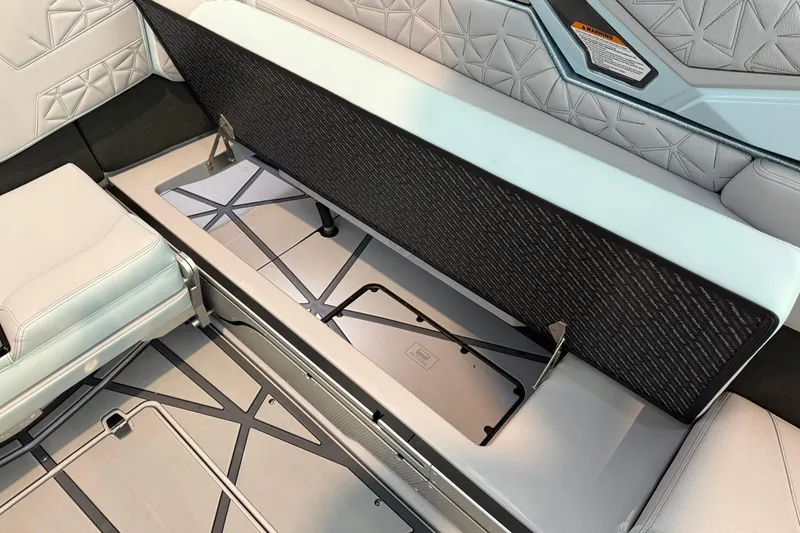 Slide: The Image of 2026 Nautique Super Air Nautique G25 Paragon interior seating with storage compartment open. - 20