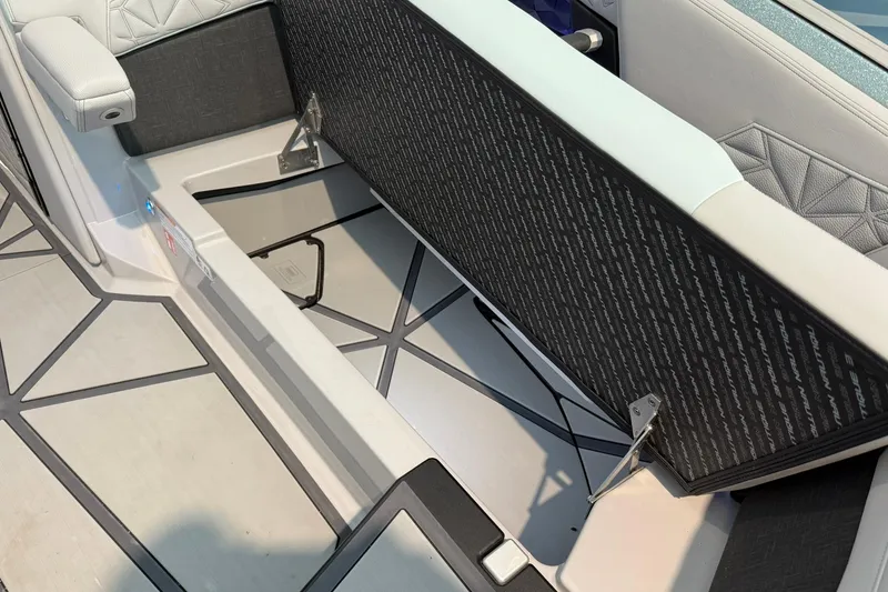 Slide: The Image of 2026 Nautique Super Air Nautique G25 Paragon interior storage compartment open. - 9