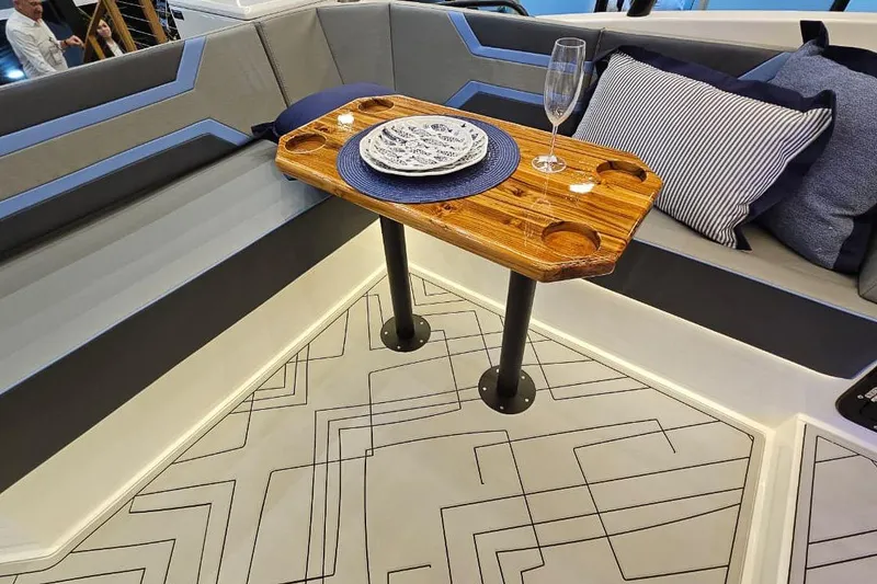 Slide: The Image of Luxurious Hanover 327 yacht interior with elegant seating and wooden table, 2026 model. - 11
