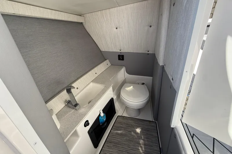 Slide: The Image of 2024 Cobalt R8 Outboard boat interior bathroom with sink and toilet. - 16