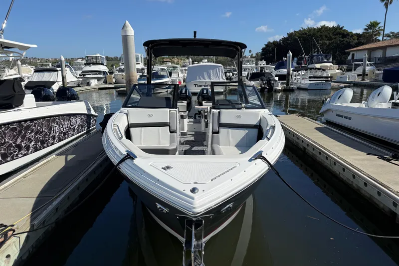 Slide: The Image of 2024 Cobalt R8 Outboard boat docked in a marina under clear blue skies. - 3