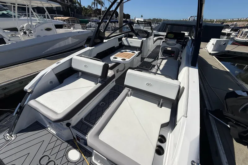 Slide: The Image of 2024 Cobalt R8 Outboard boat interior with sleek seating and modern design at a marina. - 4