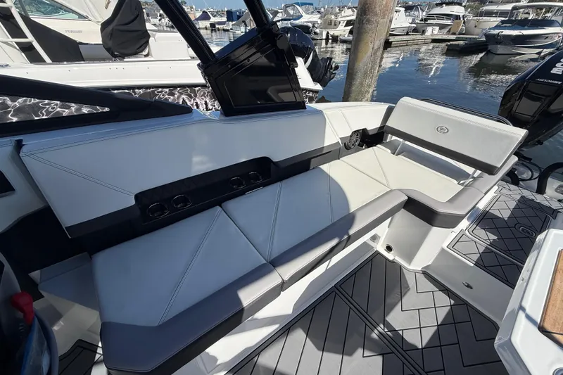 Slide: The Image of 2024 Cobalt R8 Outboard boat interior with sleek seating and modern design at a marina. - 7