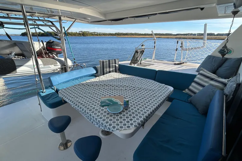 Slide: The Image of Luxurious 2013 Leopard 48 yacht interior with blue seating and scenic water view. - 10