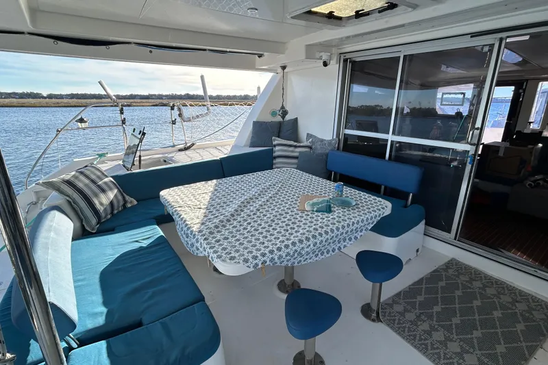 Slide: The Image of Luxurious 2013 Leopard 48 yacht with elegant outdoor seating and scenic water view. - 11