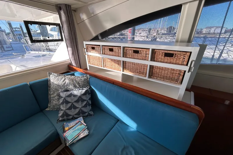 Slide: The Image of Interior of 2013 Leopard 48 yacht with blue seating and wicker storage baskets. - 16