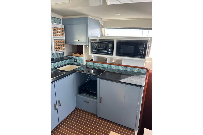 Slide: The Image of Modern kitchen in a 2013 Leopard 48 yacht with appliances and sleek cabinetry. - 20