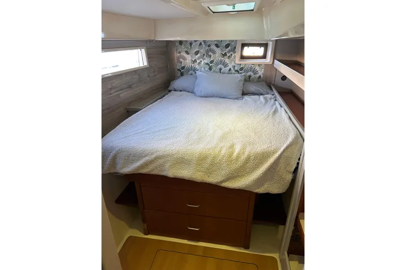 Slide: The Image of Cozy bedroom in 2013 Leopard 48 yacht with floral wallpaper and storage drawers. - 26
