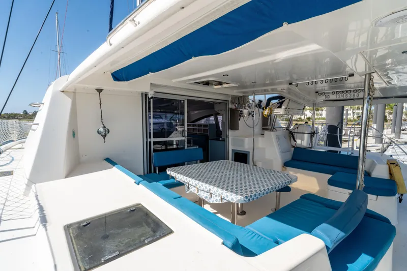 Slide: The Image of Spacious deck of 2013 Leopard 48 yacht with blue seating and dining area. - 36