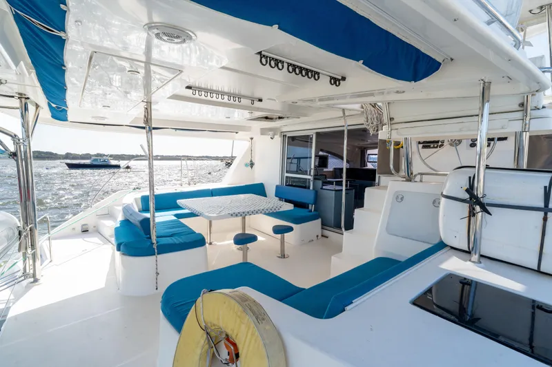 Slide: The Image of Luxurious 2013 Leopard 48 yacht interior with blue seating and dining area on deck. - 37