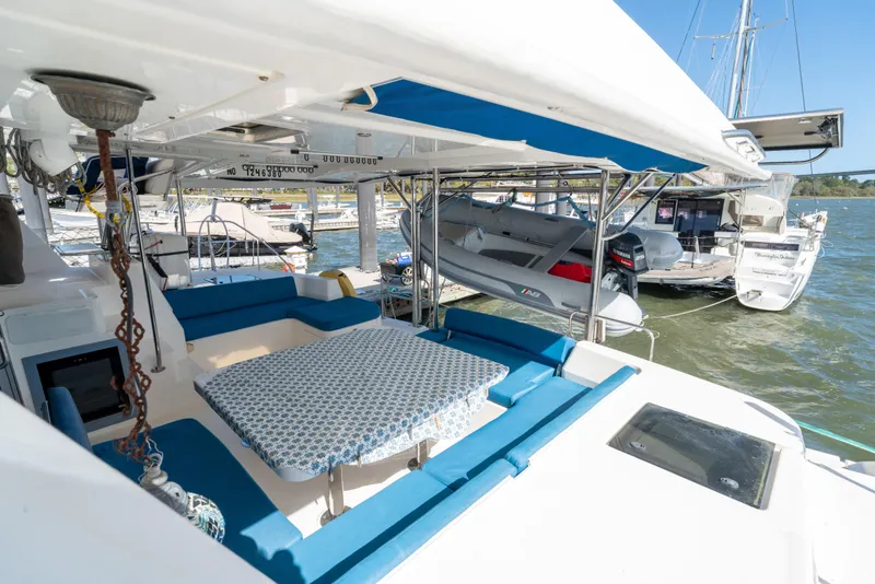 Slide: The Image of Spacious deck of 2013 Leopard 48 yacht with seating and dinghy, docked at marina. - 38