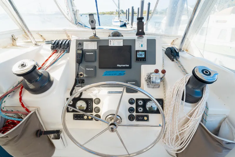 Slide: The Image of Steering console of a 2013 Leopard 48 yacht with navigation equipment and controls. - 41